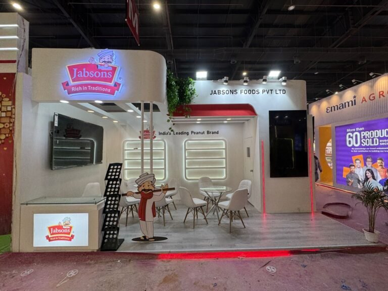 Jabsons exhibition stall featuring illuminated branding, modern display shelves, LED lighting, and an open meeting area at a trade show showcasing creative exhibition stall decoration ideas.