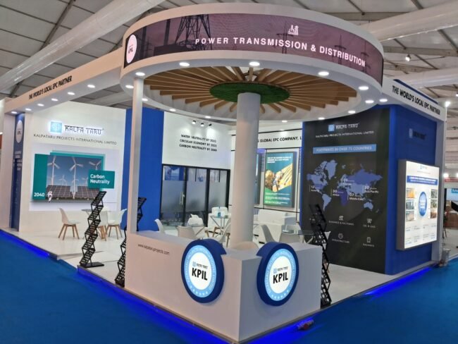 KPIL exhibition stall featuring a circular hanging display, LED branding, interactive digital screens, and modern open seating, showcasing creative exhibition stall decoration ideas at a trade show.